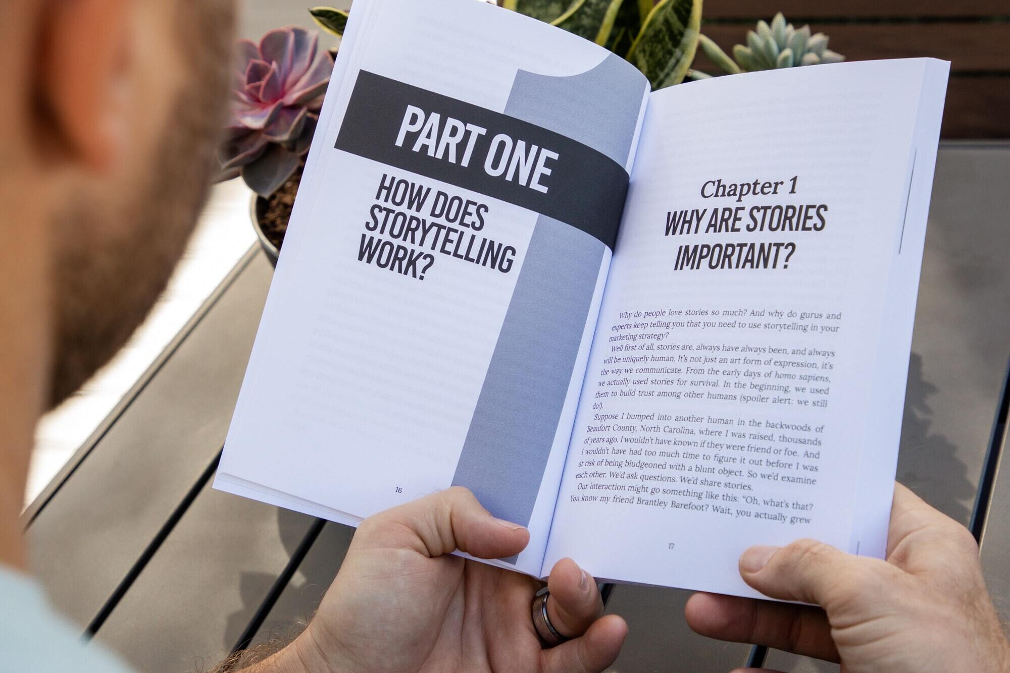 Person holding a book about storytelling and why storytelling is important.