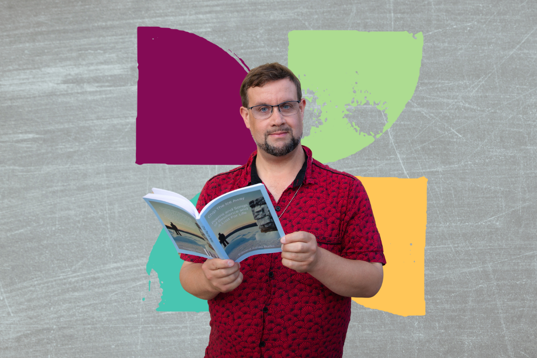 man standing with a book of poetry in his hand