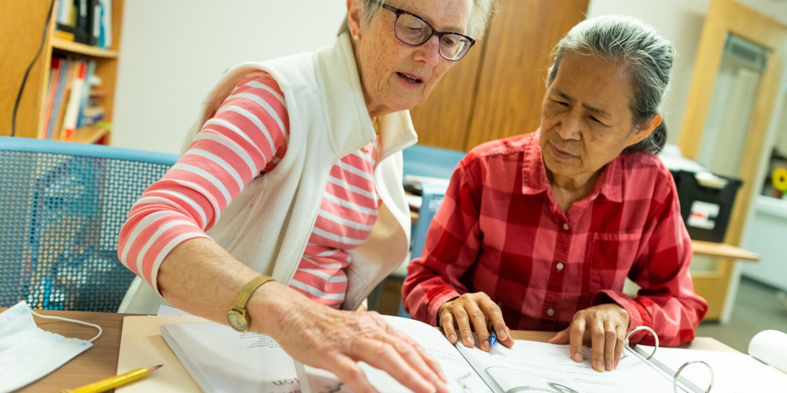 two individuals studying and practicing a foreign language