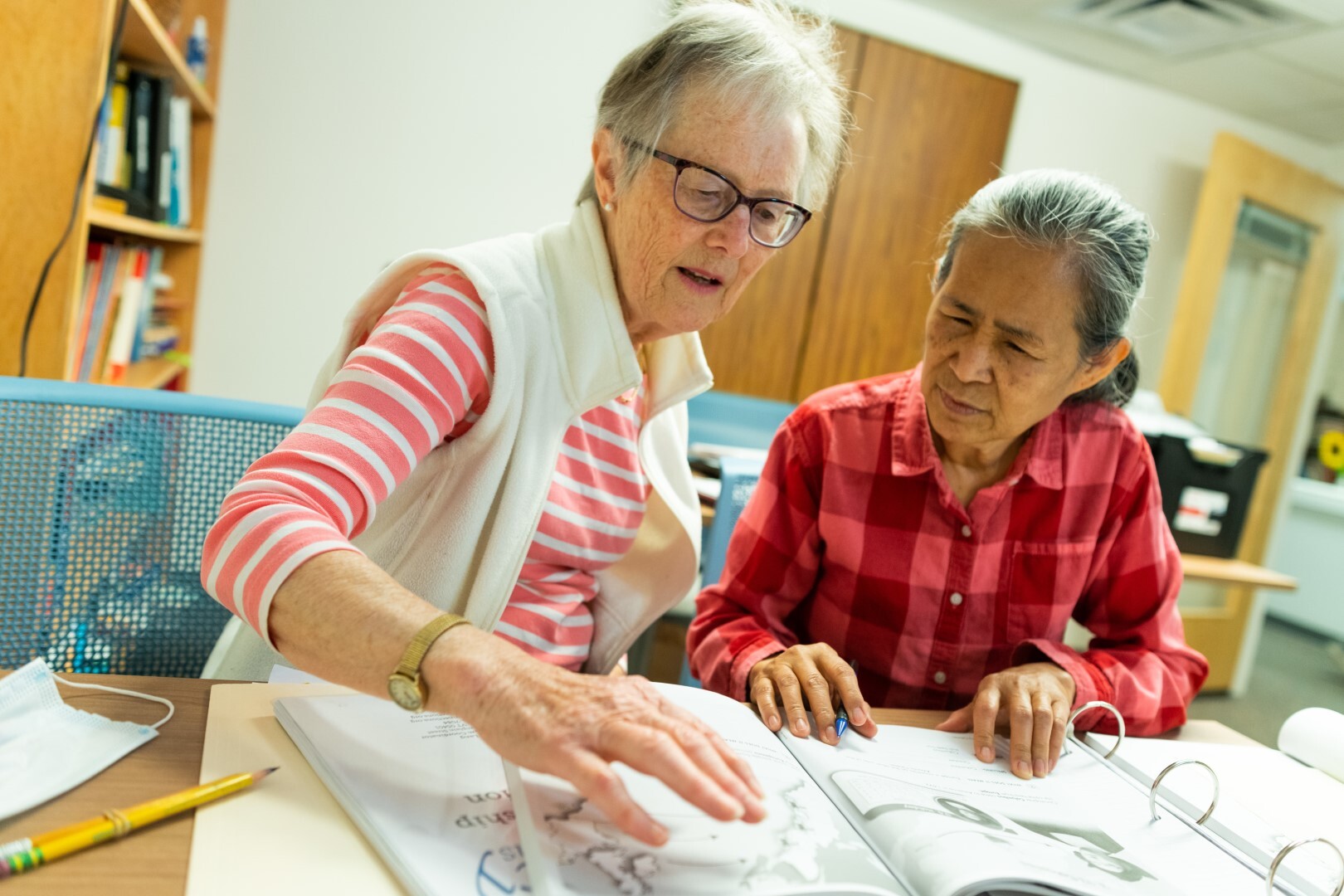 two individuals studying and practicing a foreign language